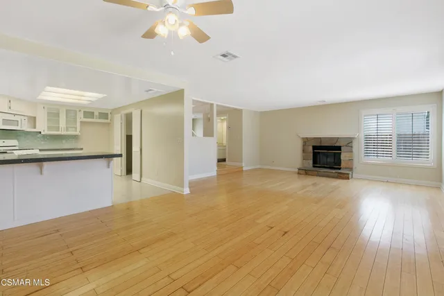 a view of livingroom with kitchen and fireplace
