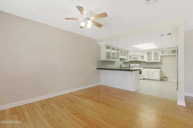 a kitchen with kitchen island a refrigerator sink and cabinets