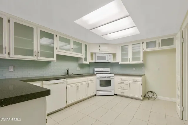 a kitchen with stainless steel appliances a stove sink and cabinets