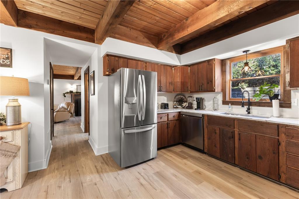 40 Kaceys Lane Helen, GA 30545 - Photo 15 of 35 a kitchen with stainless steel appliances granite countertop a refrigerator a sink dishwasher a stove and white countertops with wooden floor
