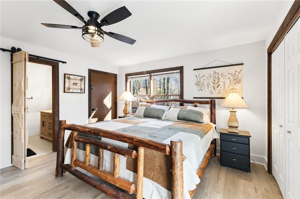 40 Kaceys Lane Helen, GA 30545 - Photo 28 of 35 a bedroom with a bed a chandelier and dresser