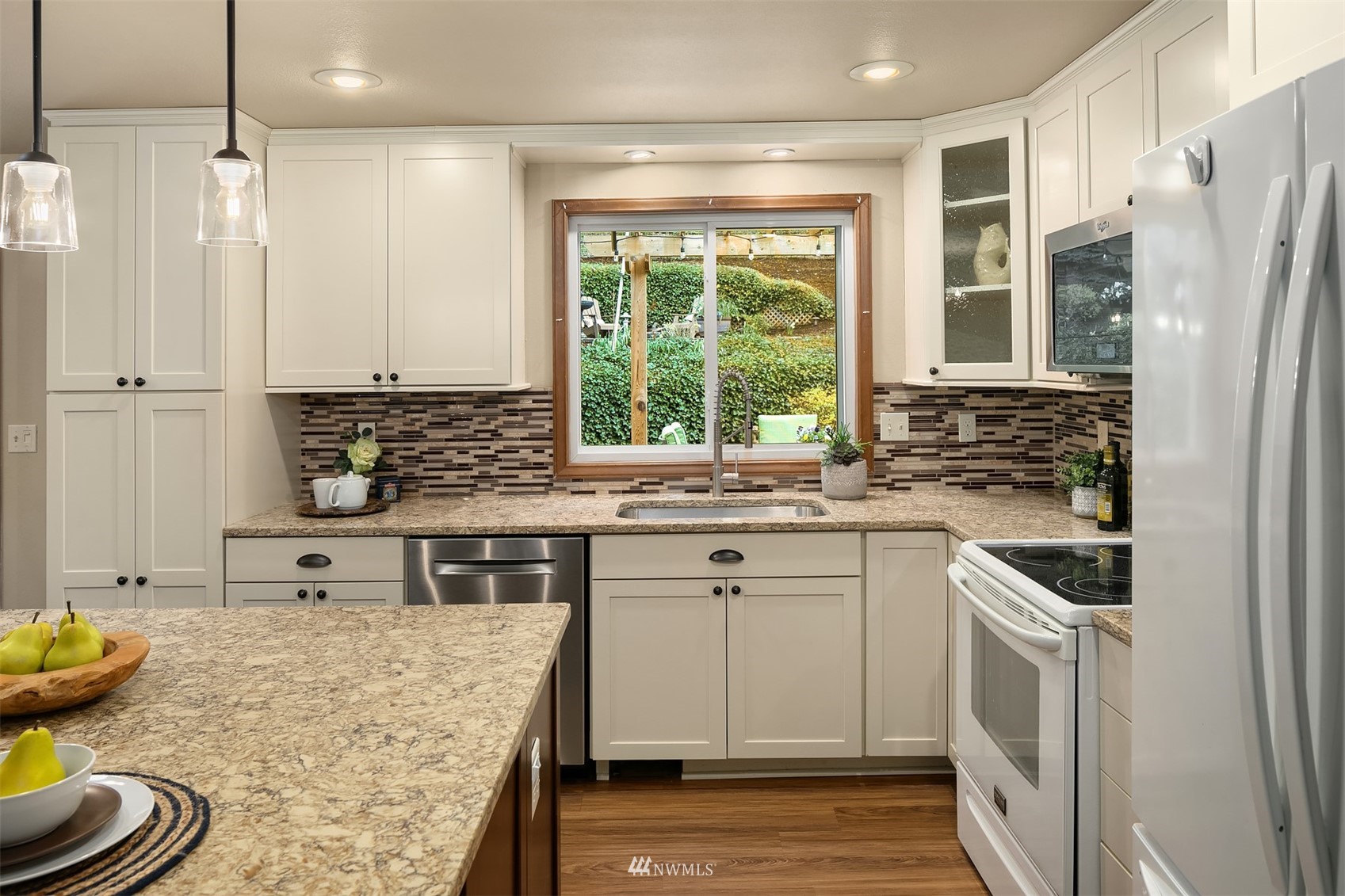 21832 Northeast 8th Street Sammamish, WA 98074 - Photo 14 of 40 a kitchen with stainless steel appliances granite countertop a stove a sink and a refrigerator