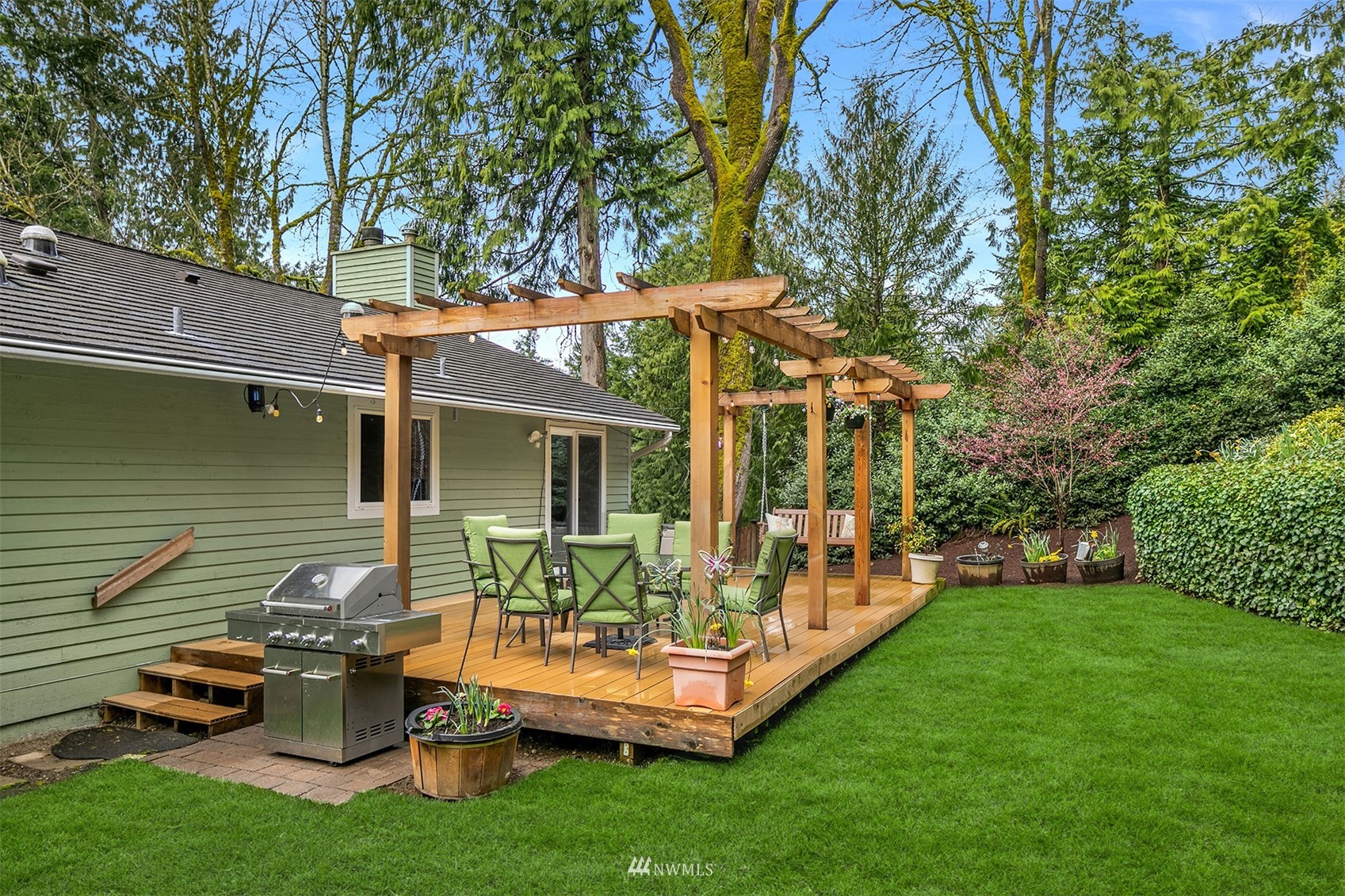 21832 Northeast 8th Street Sammamish, WA 98074 - Photo 28 of 40 a backyard of a house with table and chairs