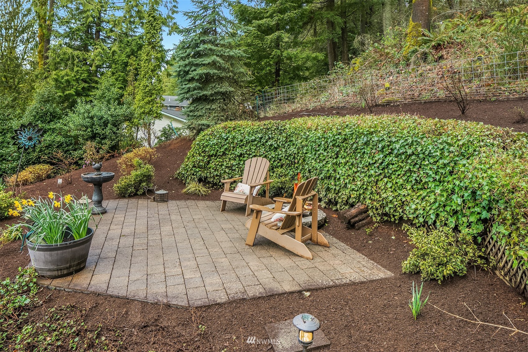 21832 Northeast 8th Street Sammamish, WA 98074 - Photo 32 of 40 a view of a backyard with chair potted plants