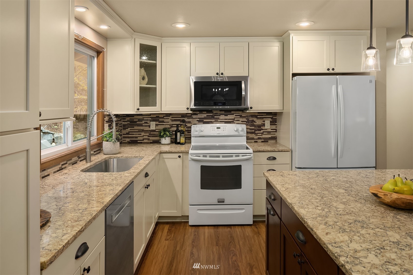 21832 Northeast 8th Street Sammamish, WA 98074 - Photo 10 of 40 a kitchen with stainless steel appliances granite countertop a sink stove and refrigerator
