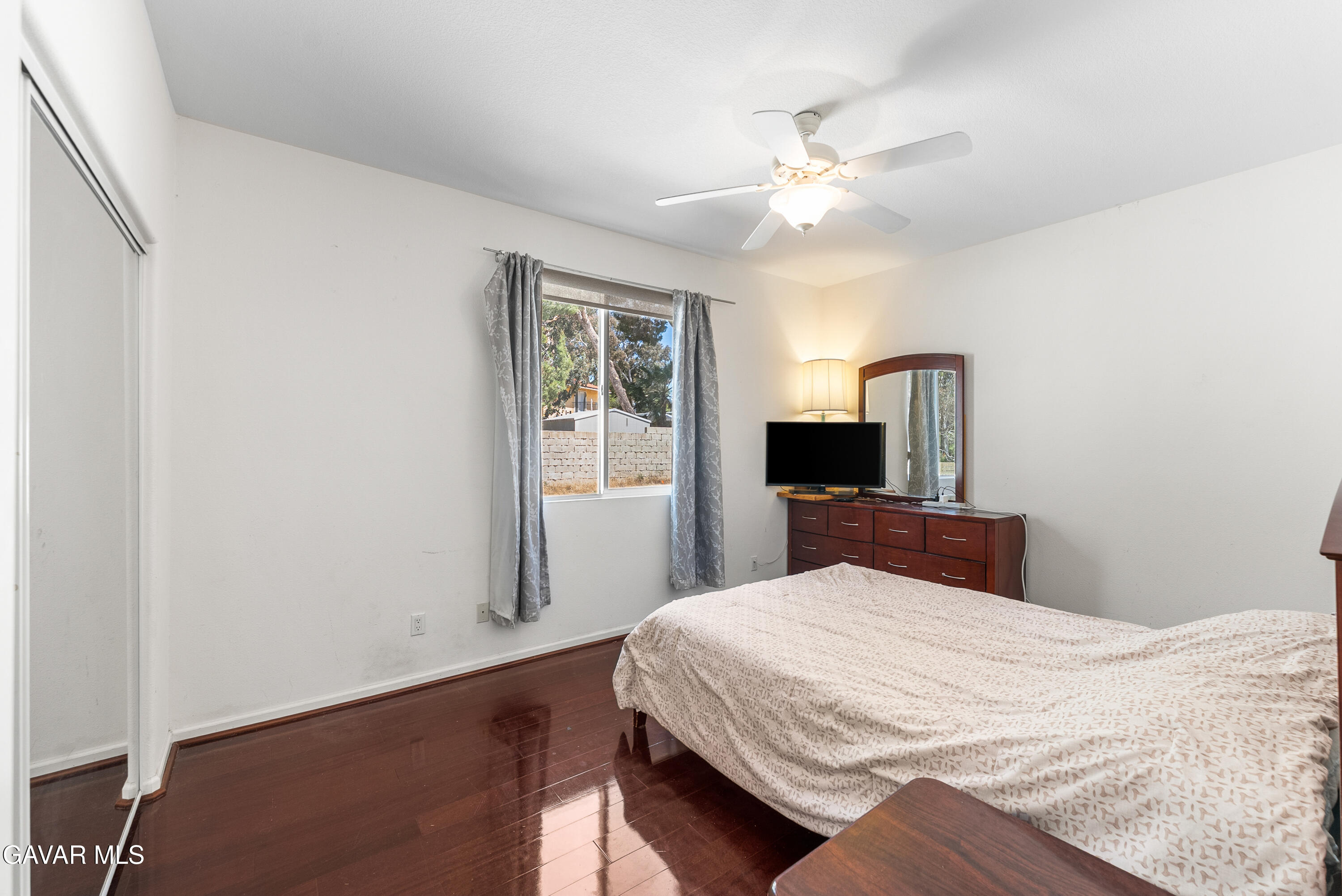 658 Lago Lindo Road Palmdale, CA 93550 - Photo 36 of 91 a bedroom with a large bed and a chandelier
