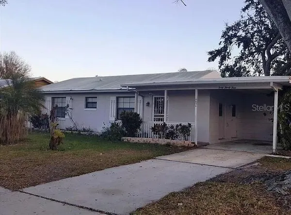 a front view of a house with a garden and yard