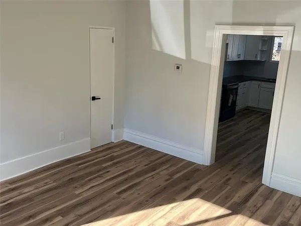 a view of bedroom with wooden floor
