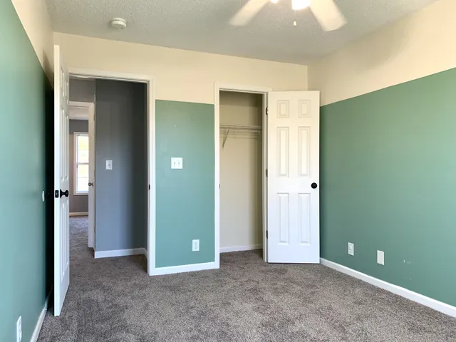 an empty room with closet and a bathroom