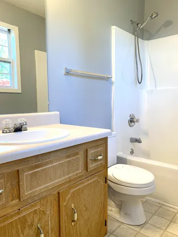 a bathroom with a granite countertop toilet sink and shower