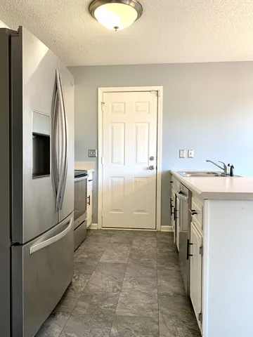 a kitchen with a refrigerator sink and stove