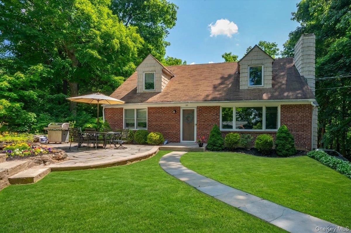 105 High St Extension Mount Kisco, NY 10549 - Photo 3 of 38 a front view of a house with a yard table and chairs