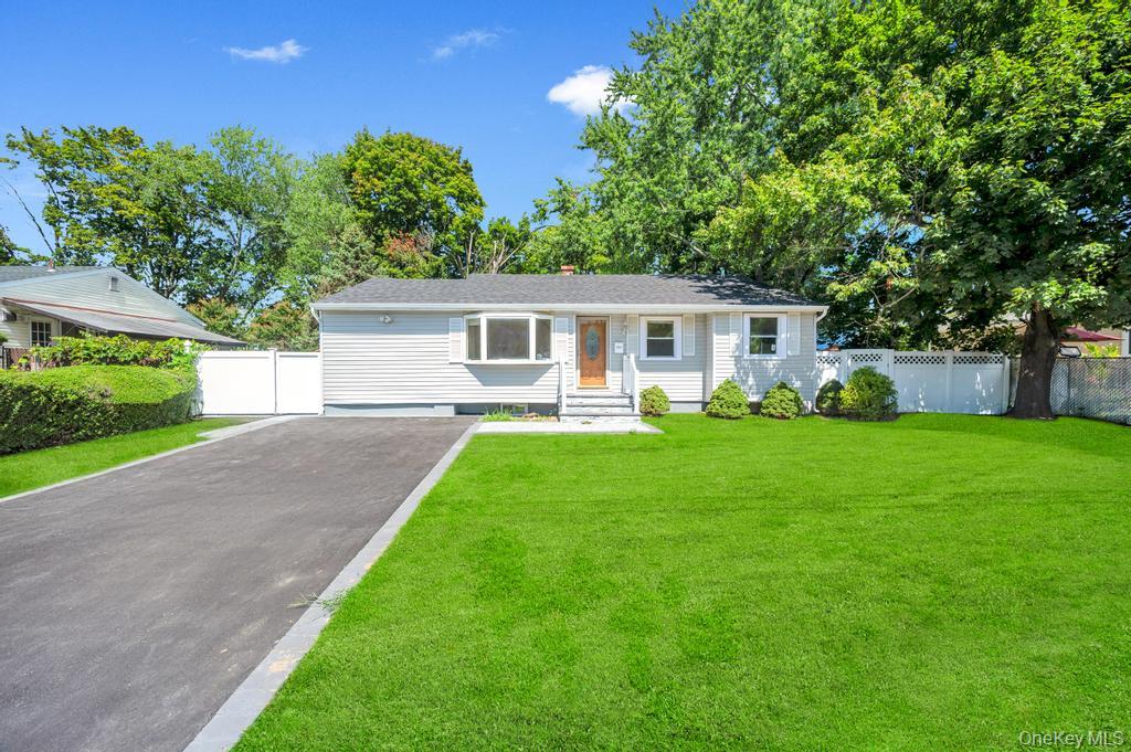 Ranch-style house with asphalt driveway and a chimney