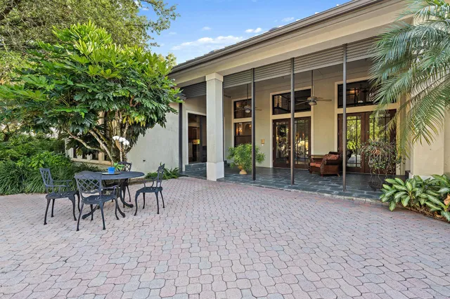a view of a patio with table and chairs and potted plants