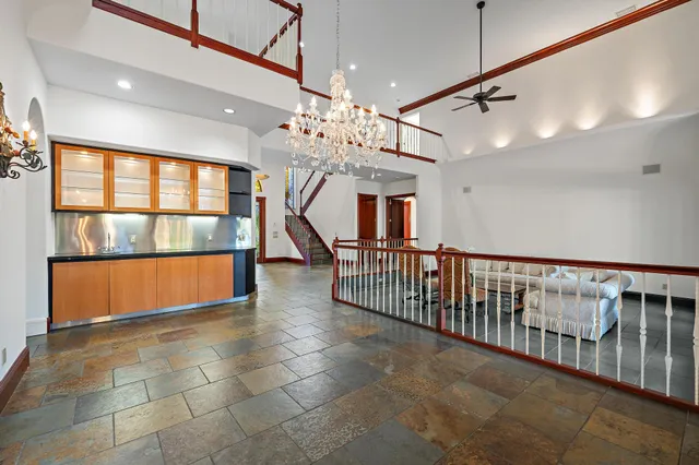 a view of a room with lots of windows and wooden floor