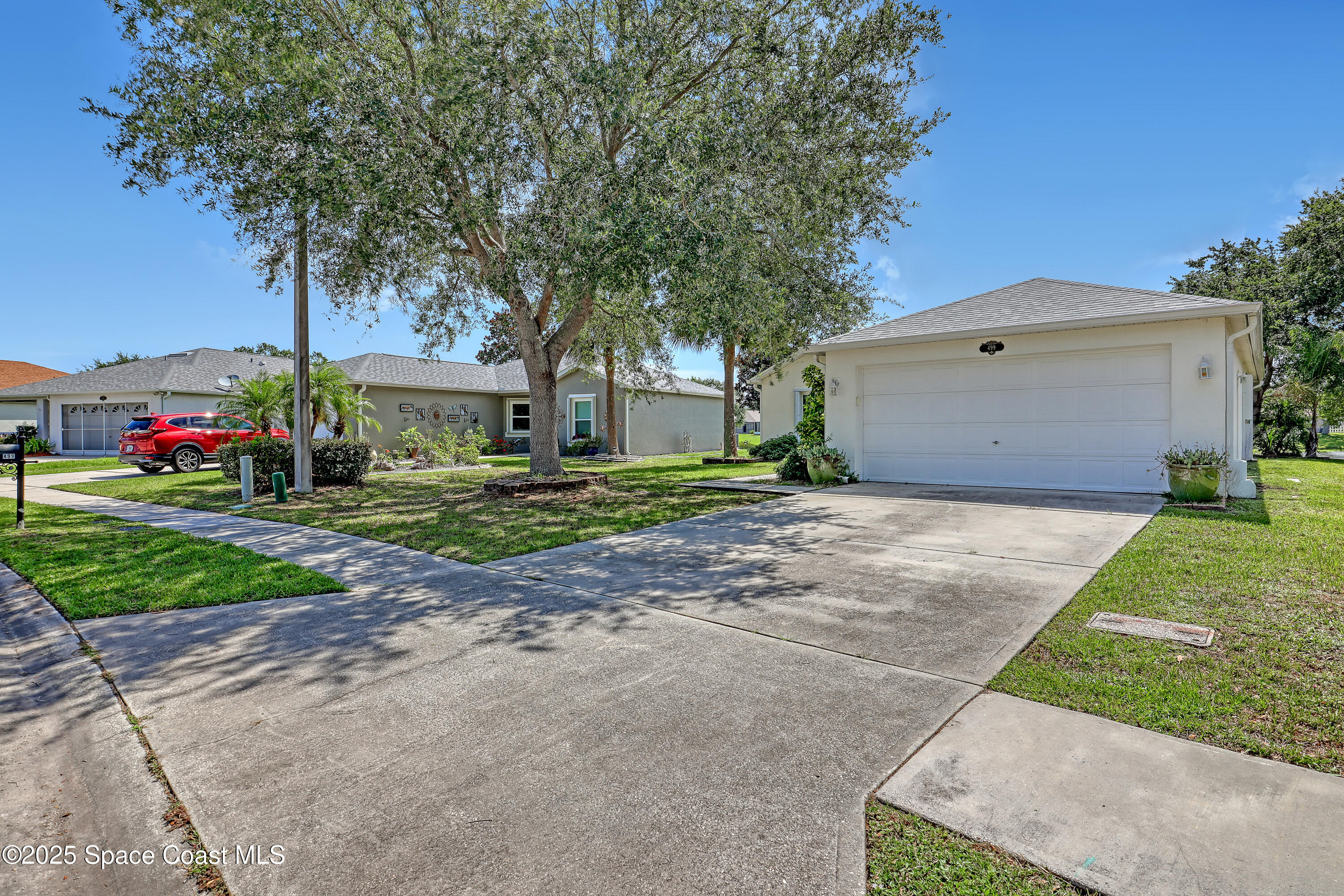 a front view of house with yard and green space