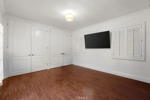 a view of a livingroom with wooden floor and a flat screen tv