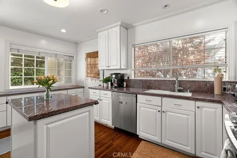 a kitchen with granite countertop a sink and a window