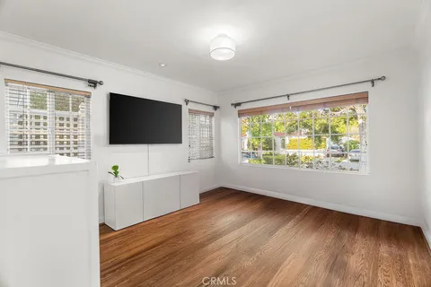a living room with a flat screen tv and a floor to ceiling window