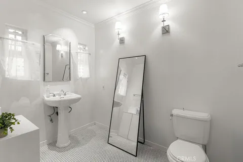 a bathroom with a sink toilet and a mirror