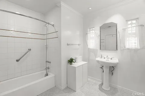 a bathroom with a sink a mirror and a bathtub