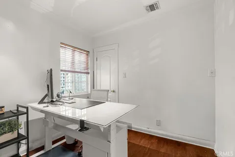 a room with a table chairs and a window