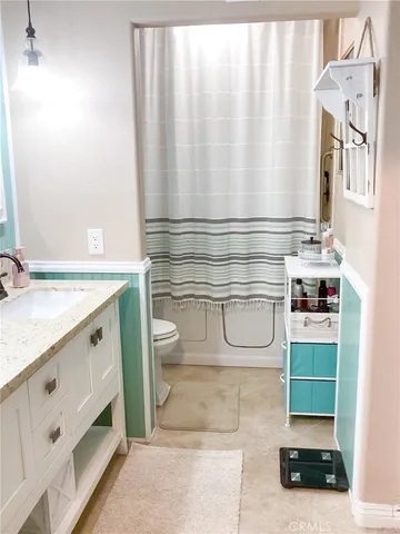 a view of a walk in closet and bathroom