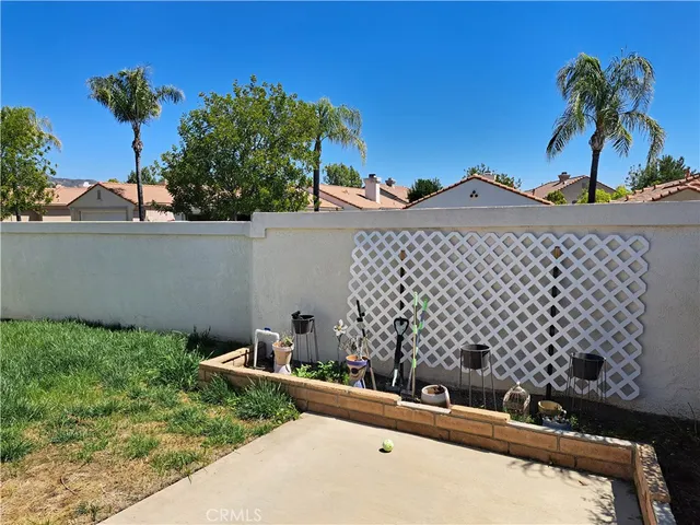 a view of balcony with couple of chairs and a table