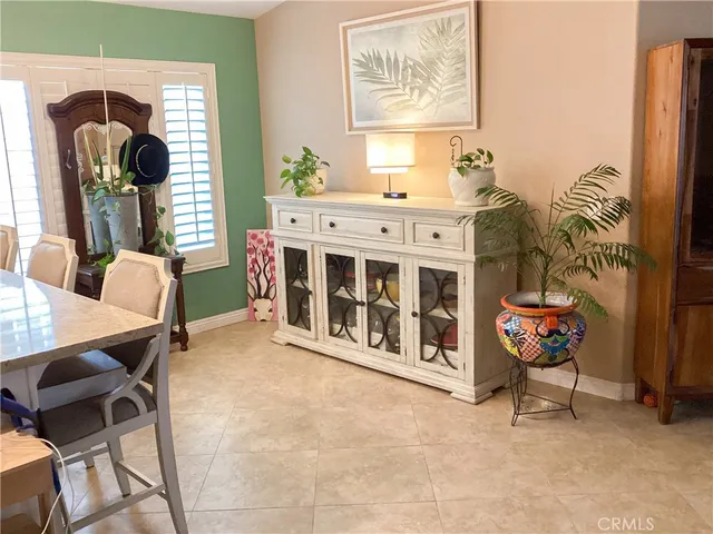 a dining hall with stainless steel appliances granite countertop a dining table chair and a refrigerator