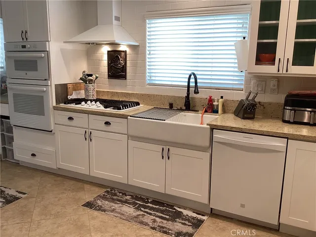 a bathroom with a double vanity sink a mirror a and window