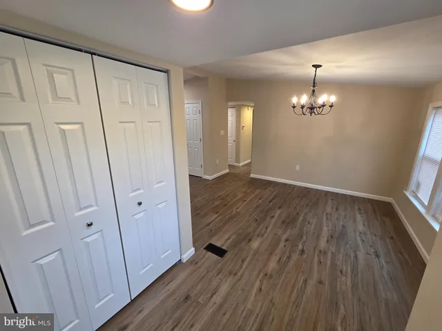 wooden floor in an empty room with a mirror