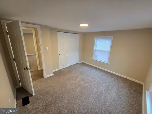 a view of an empty room and a window