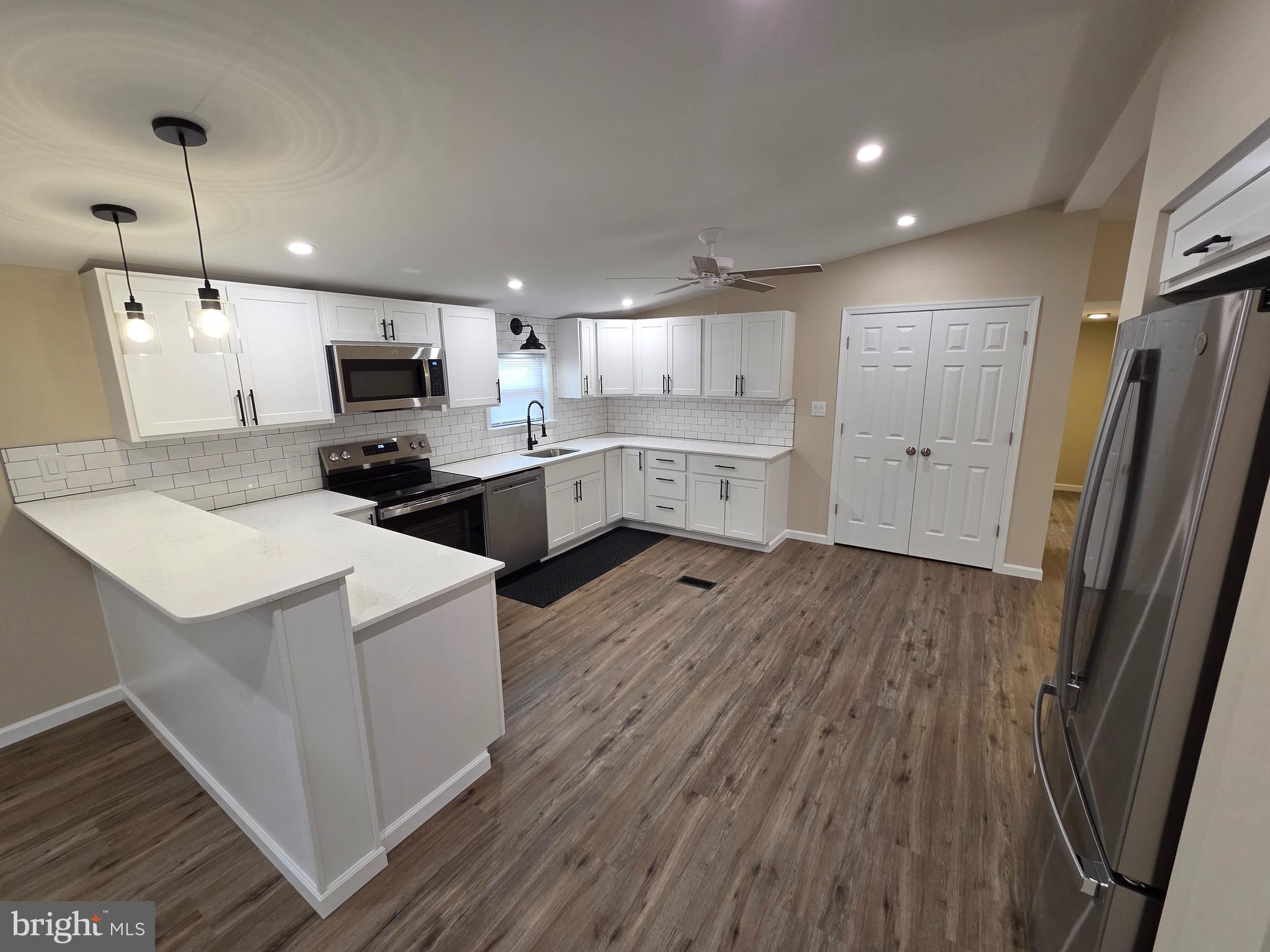 450 Ford Hook Road Doylestown, PA 18901 - Photo 7 of 21 a kitchen with kitchen island wooden floors appliances and cabinets