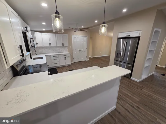 a large room with wooden floor and windows