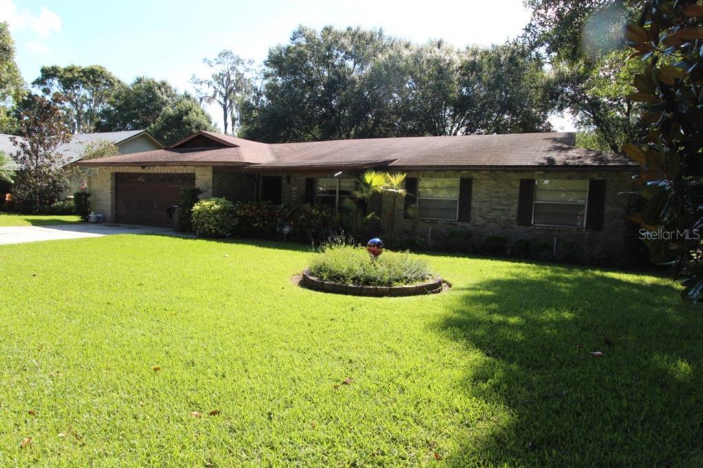 4052 Stone Henge Road Mulberry, FL 33860 - Photo 1 of 1 a front view of house with yard and green space