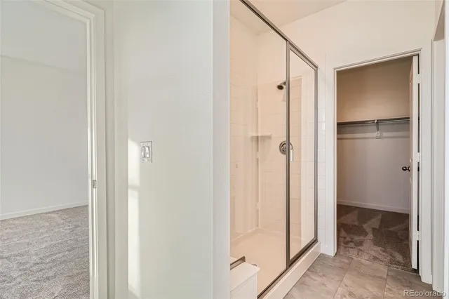 a bathroom with a shower and a glass door
