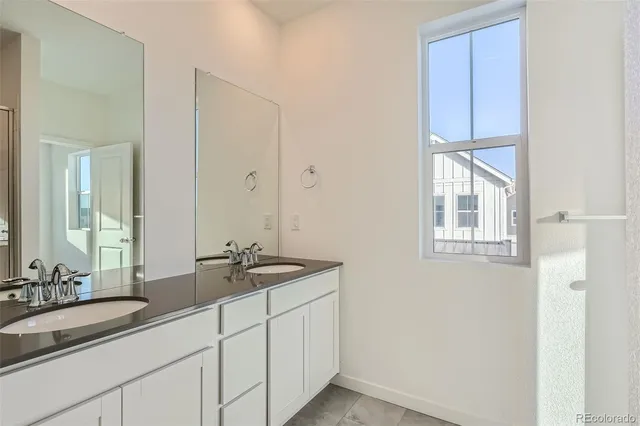a bathroom with a double vanity sink and a mirror