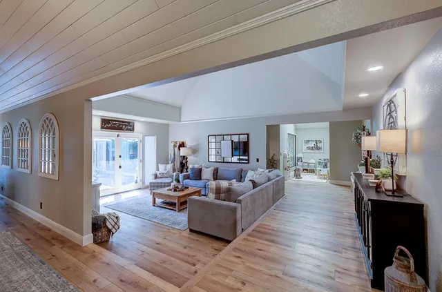 a living room with furniture and a wooden floor