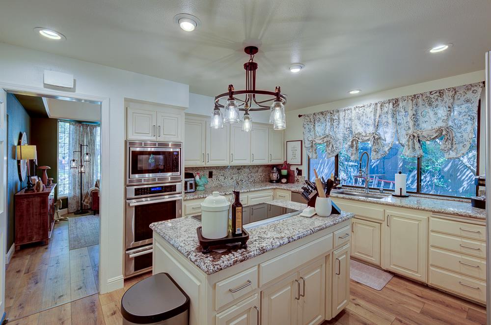 2555 West Bluff Avenue, Unit 152 Fresno, CA 93711 - Photo 18 of 45 a kitchen with stainless steel appliances kitchen island granite countertop a sink and cabinets