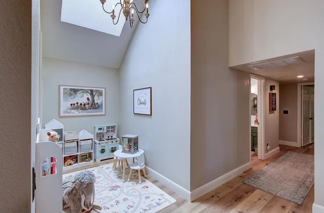 a living room with furniture and a chandelier