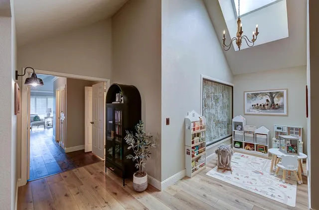 a view of a livingroom with wooden floor and furniture