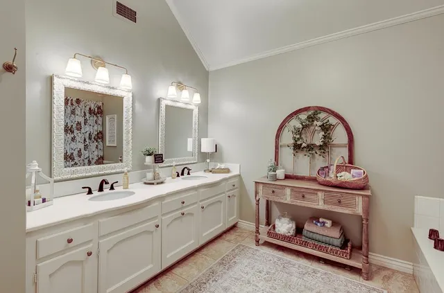 a bathroom with a double vanity sink and a mirror