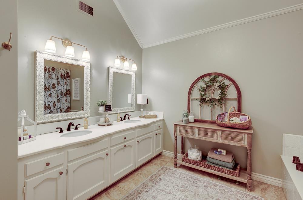 2555 West Bluff Avenue, Unit 152 Fresno, CA 93711 - Photo 24 of 45 a bathroom with a double vanity sink and a mirror