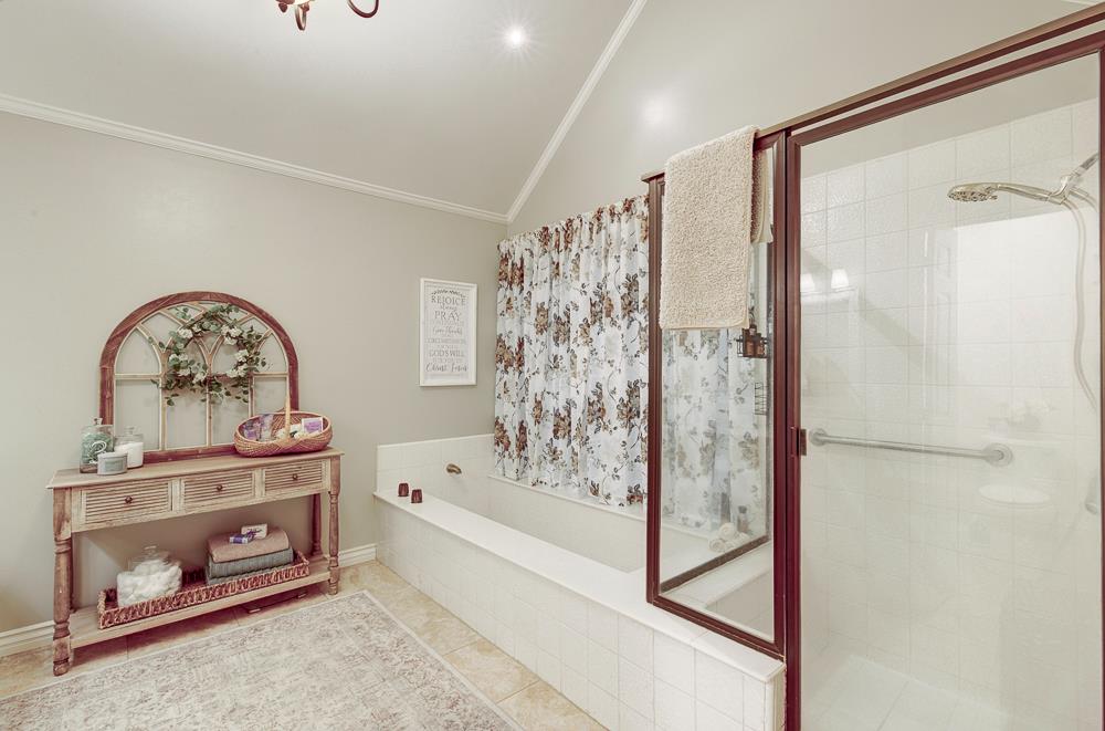 2555 West Bluff Avenue, Unit 152 Fresno, CA 93711 - Photo 25 of 45 a bathroom with a bathtub and a shower