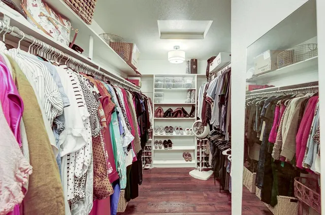 a view of walk in closet with clothes