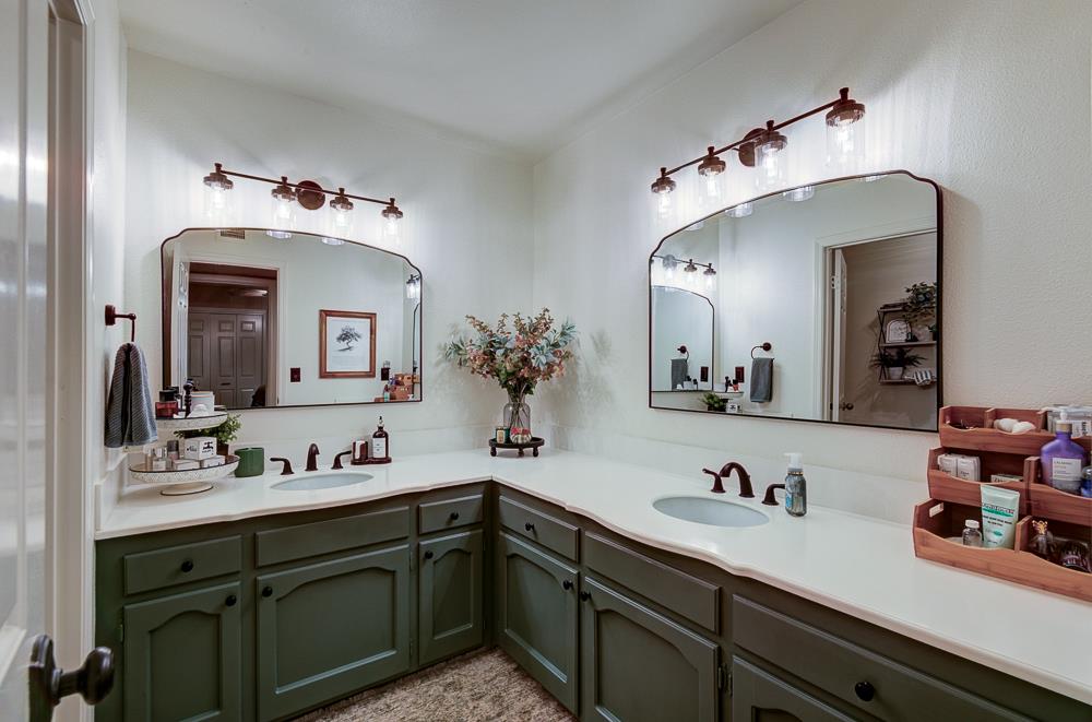 2555 West Bluff Avenue, Unit 152 Fresno, CA 93711 - Photo 27 of 45 a bathroom with a sink and large mirror