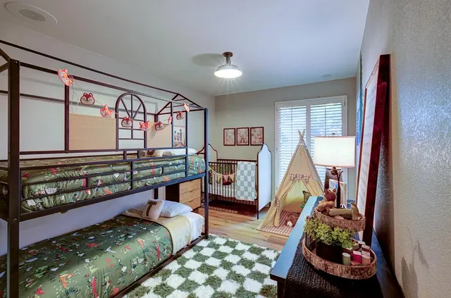 a bedroom with furniture and a large window