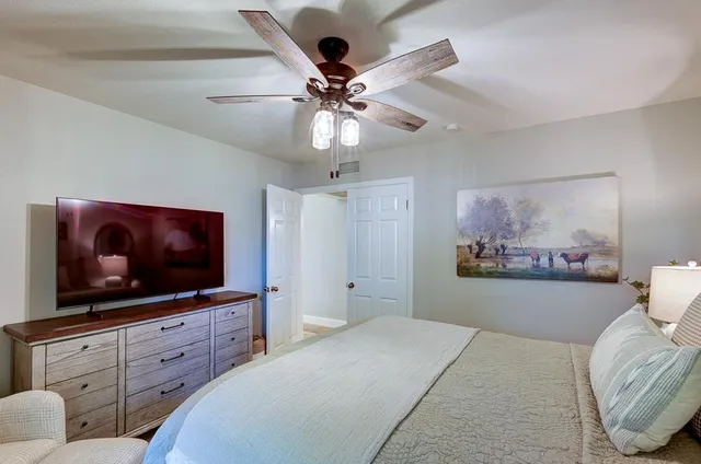 a bedroom with a bed and a flat screen tv