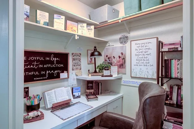 a living room with furniture and paintings on the wall