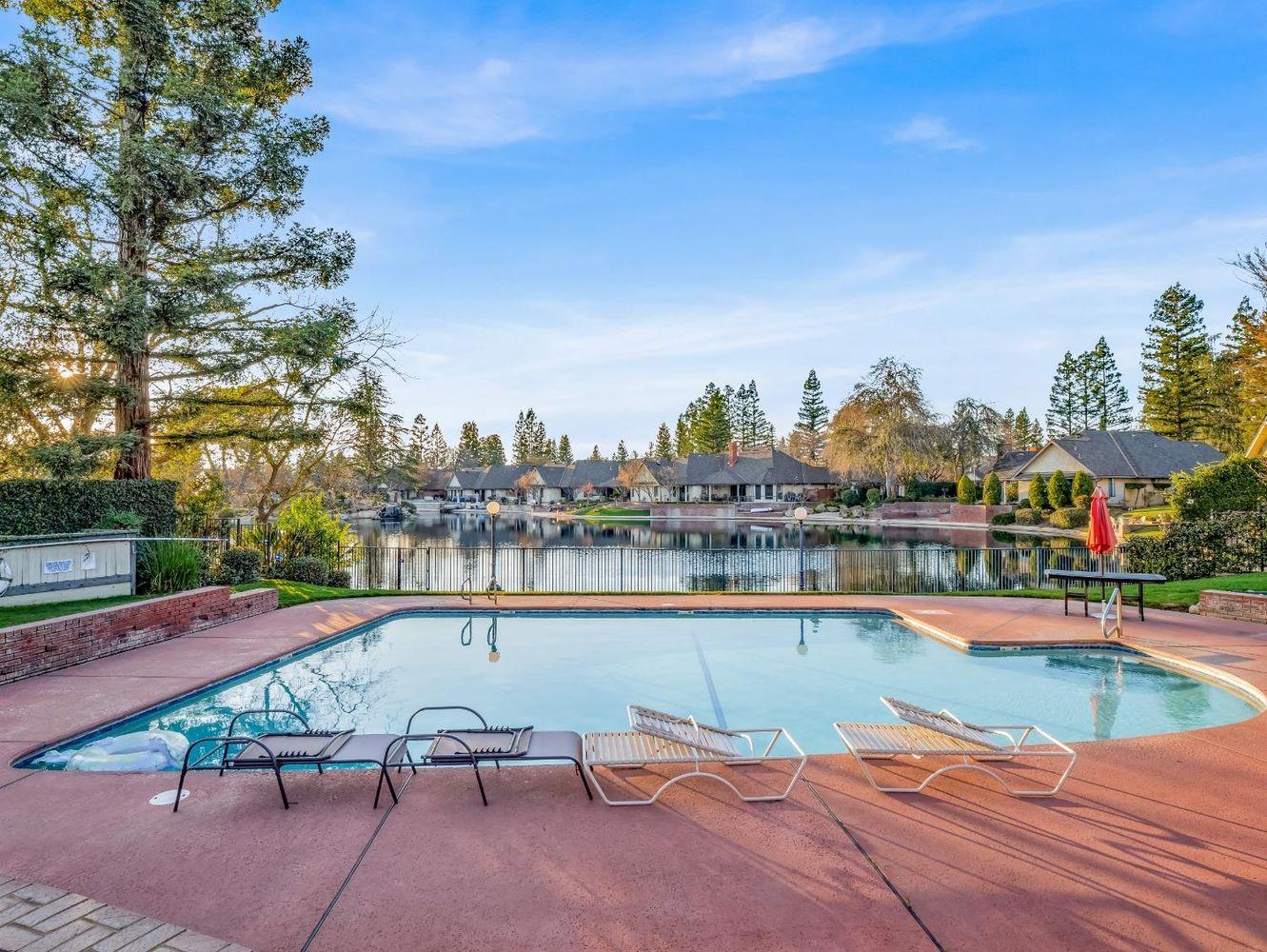 2555 West Bluff Avenue, Unit 152 Fresno, CA 93711 - Photo 43 of 45 a view of a lake with a table and chairs